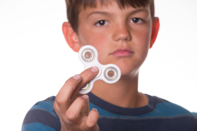 Boy Holding a Fidget Spinner